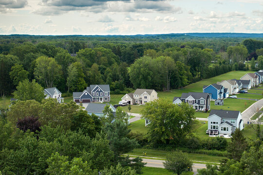 View from above of residential houses in living area in Rochester, NY. American dream homes as example of real estate development in US suburbs