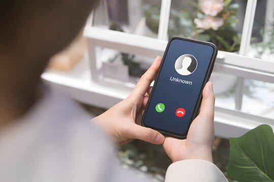 Woman holding mobile phone with incoming call from unknown caller. scammer or stranger, Hoax person with fake identity, Prank caller, anonymous, smartphone, Fraud or phishing concept,