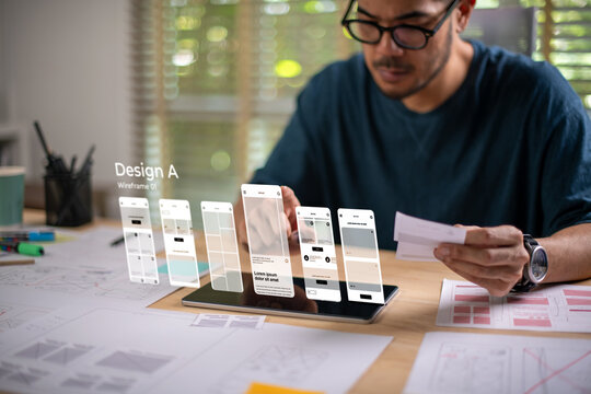 A male designer working on website prototype, in UX UI concept design and development for a website and mobile app prototype, with hologram interface