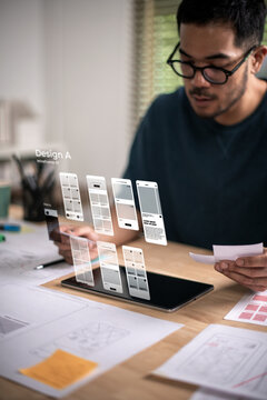 A male designer working on website prototype, in UX UI concept design and development for a website and mobile app prototype, with hologram interface