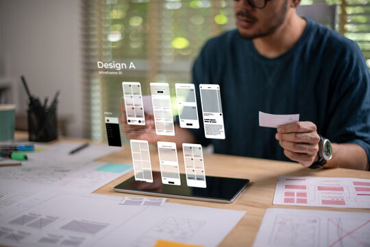 A male designer working on website prototype, in UX UI concept design and development for a website and mobile app prototype, with hologram interface