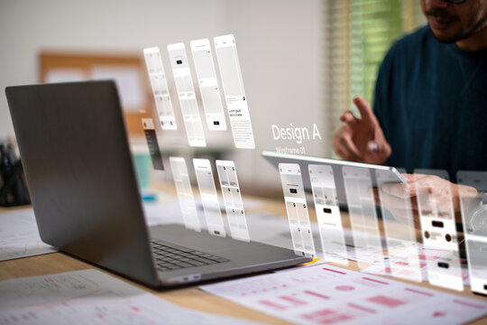 A male designer working on website prototype, in UX UI concept design and development for a website and mobile app prototype, with hologram interface