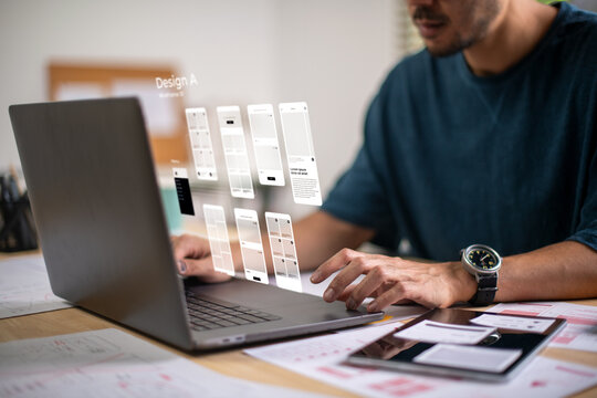 A male designer working on website prototype, in UX UI concept design and development for a website and mobile app prototype, with hologram interface