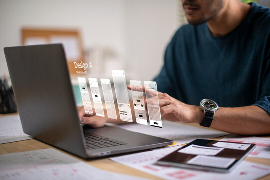 A male designer working on website prototype, in UX UI concept design and development for a website and mobile app prototype, with hologram interface