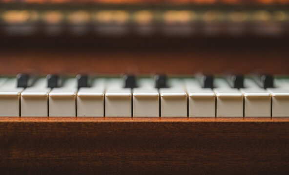 Minimal dark piano keyboard detail with soft dramatic focus.