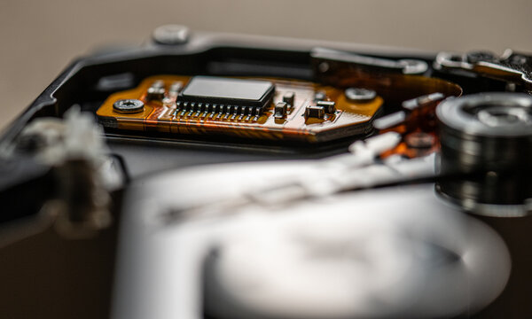 Electronic control board inside open hard drive showing microchip details.