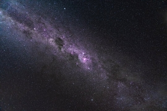 View of the Milky Way galaxy stretching across the night sky above the Marlborough Sounds in Linkwater, Marlborough Region, New Zealand.