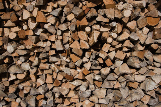 Wood logs pilled up with different shapes pattern