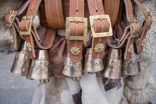 Brass bells on leather belts for Kukeri costumes at a market in Bulgaria.