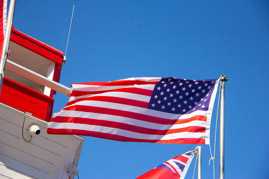 American flagflying next to a lighthouse