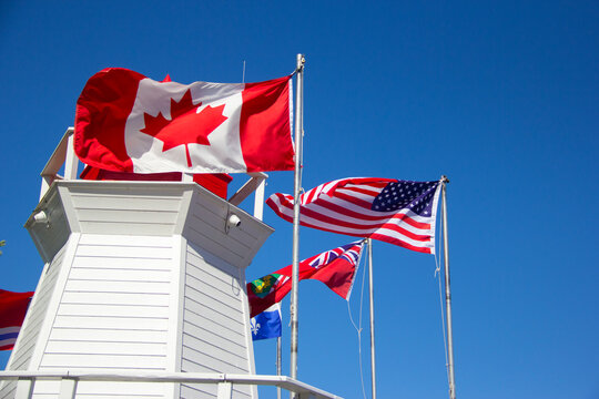 American and Canadian flags next to a lighthouse