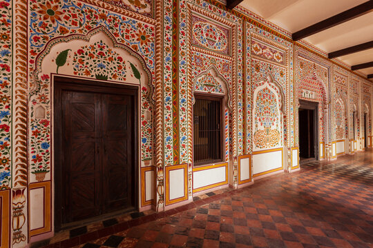 View of the intricately painted floral walls and traditional wooden doors of the historic Saidpur village architecture in Saidpur, Islamabad Capital Ter, Pakistan.