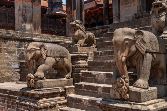 View of stone elephant statues guarding the entrance steps at Bhaktapur Durbar Square, featuring intricate carvings and traditional Newari architecture in Bhaktapur, Bagmati Province, Nepal.