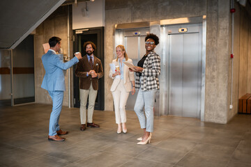 Fototapeta premium Business colleagues networking during office coffee break near elevators