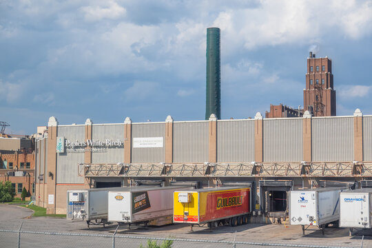 Quebec City, QC, Canada. July 30, 2026. Wide shot of Papiers White Birch paper mill loading docks with semi-truck trailers parked.