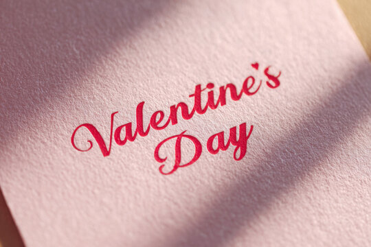 Red Script Typography Valentines Day Lettering on Textured White Paper Close-Up