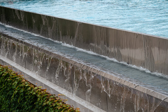 Water flow over a metal edge at a relaxation area in a city