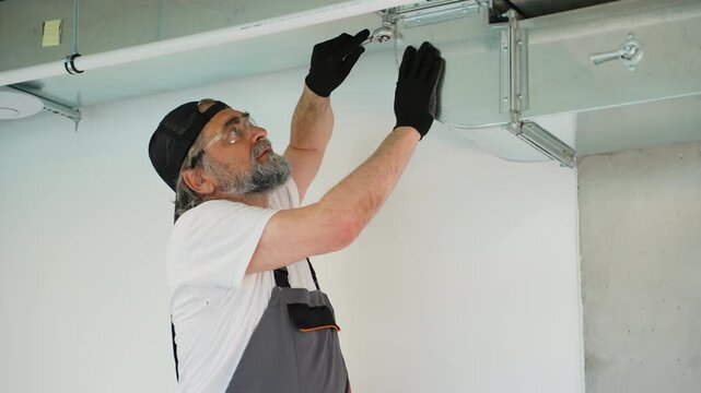 Hvac technician installing air duct ventilation system