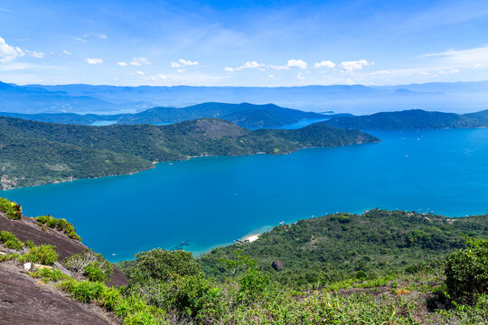View of Mamangua Bay surrounded by lush green hills and turquoise waters in Paraty, Rio de Janeiro, Brazil.