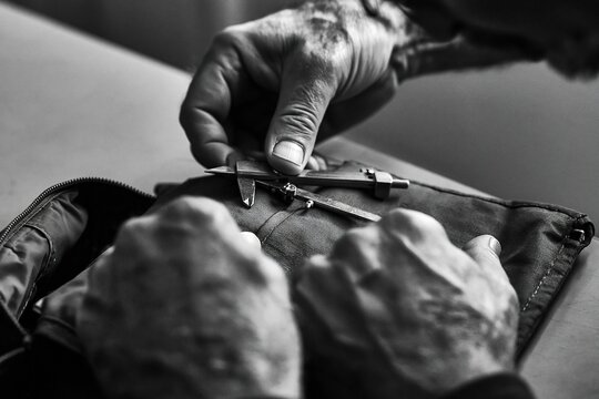 Hands Unzipping Jacket, Close-Up