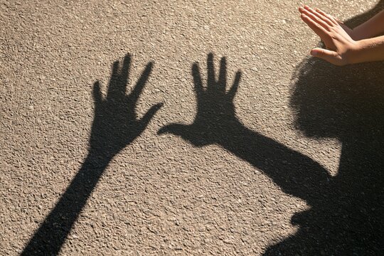 Shadow of Two Hands Reaching Out