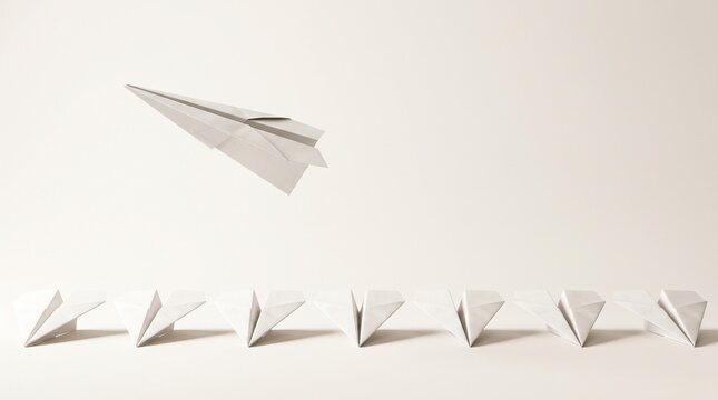 One Folded Paper Airplane Flying Above Ordinary Paper Planes