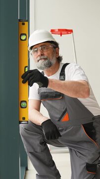 Construction worker using spirit level tool