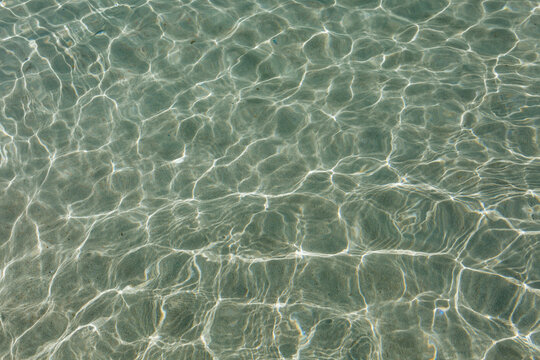 Crystal Clear Seawater with Sunlight Reflections and Gentle Ripples