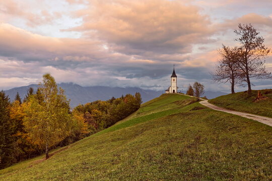 St.Primus and Felician hilltop Gothic church on a grassy ridge backed by the Karavanke mountains, on a cloudy autumn afternoon. Jamnik-Slovenia-176