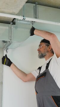 Professional hvac technician installing air duct system