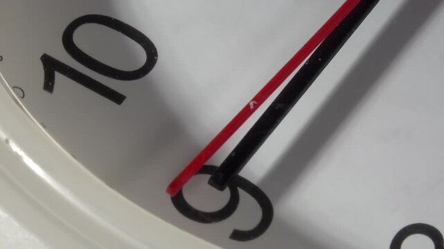 Top view macro of clock face rotating on turntable with second hand stuck due to low battery (Version 2)