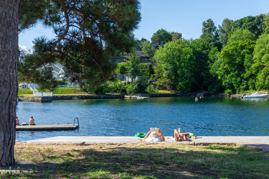 People relaxing sunbathing at Bekkelagsbadet in Oslo, Norway
