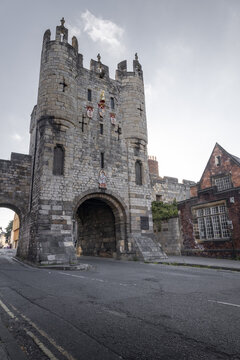 View of Monk Bar, a historic stone gatehouse with heraldic shields and medieval architecture, located in York, England, United Kingdom.