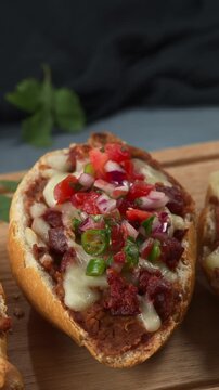 Freshly baked bolillo toast with refried beans, cheese and chorizo topped with pico de gallo