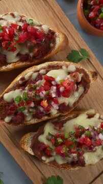 Traditional Mexican Breakfast. Molletes with Melted Cheese, Chorizo, and Fresh Pico de Gallo