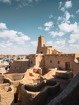 View of the ancient mud-brick architecture of Shali Fortress under a bright blue sky in Siwa, Marsa Matrouh Governo, Egypt.