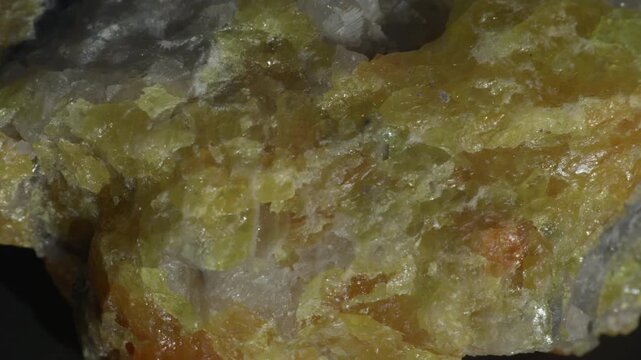 Yellow fluorite crystals in calcite matrix isolated on a black background