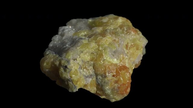 Yellow fluorite crystals in calcite matrix isolated on a black background