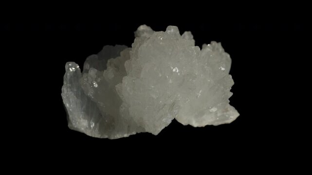 White celestine crystals isolated on a black background