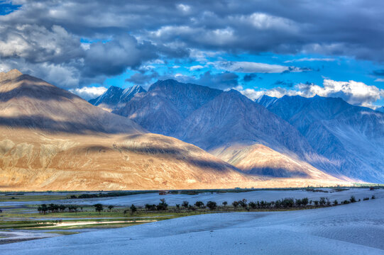 Scene featuring high dynamic range view valley in Himalayas. with sand dunes. Hunder, Nubra valley, Ladakh, India