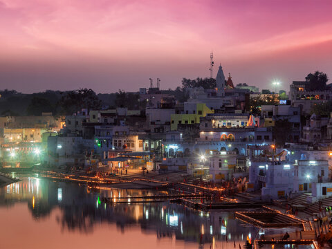 Sacred Puskhar lake (Sagar) alongside ghats of town Pushkar in twilight in the evening, Rajasthan, India