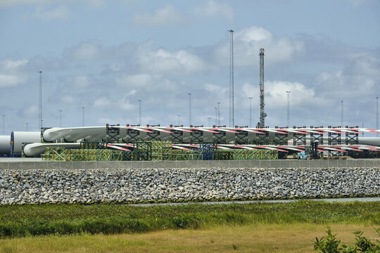 View of wind turbine blades stacked in racks on the harbor quay in Esbjerg, Syddanmark, Denmark.