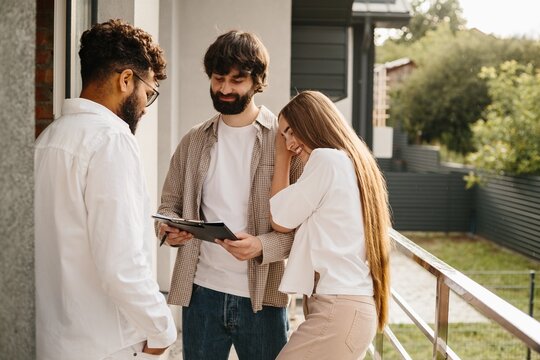 Real estate agent discussing contract with couple