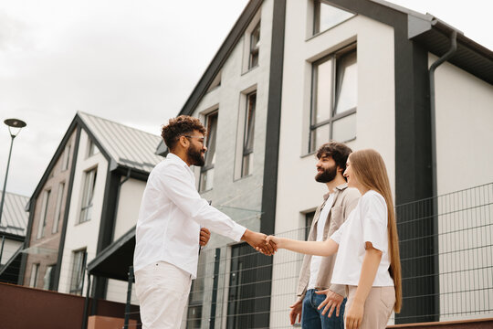 Real estate agent shaking hand with client