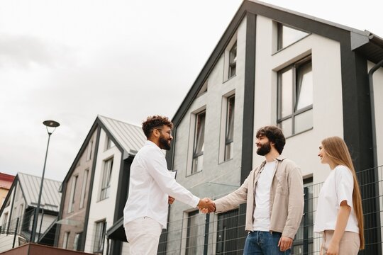 Realtor closing real estate deal with young couple
