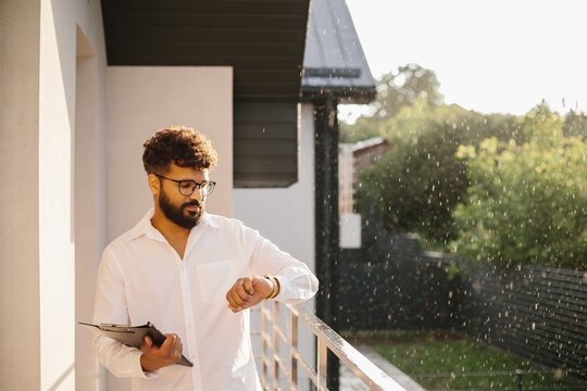 Real estate agent checking watch before client meeting
