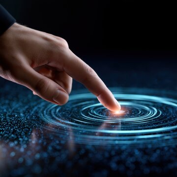 Finger touching futuristic digital touchscreen interface creating glowing ripple effect with circular light patterns on dark background