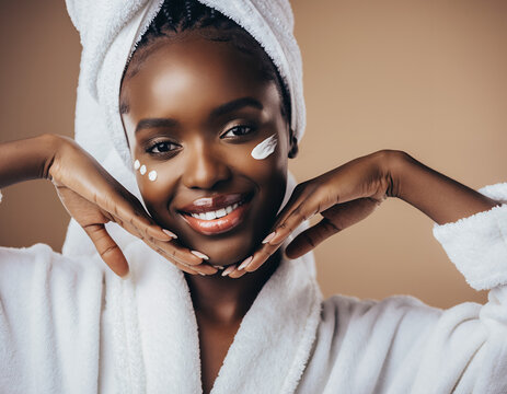 Smiling African American Woman with Face Cream in White Spa Bathrobe