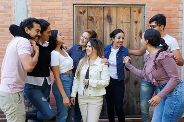 Fototapeta premium group of latin and multigenerational people or family together in a terrace outdoors in Mexico Latin america. Portrait of diverse hispanic group of friends