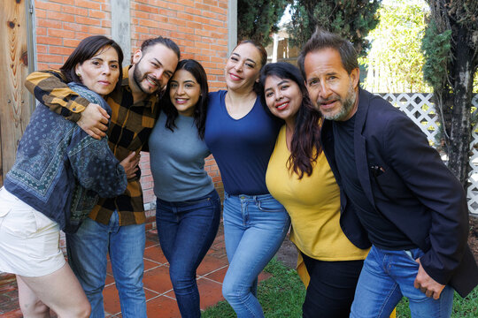 group of latin and multigenerational people or family together in a terrace outdoors in Mexico Latin america. Portrait of diverse hispanic group of friends